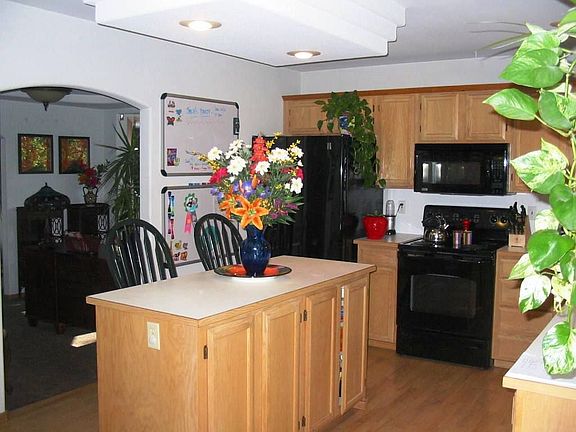 Hardwood floors,  oak cabinets, island, new appliances & recessed lighting.