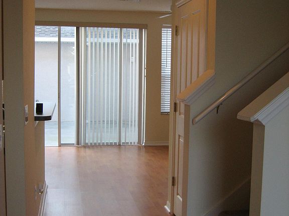 Hallway with storage under stairs and stairs to the upper level