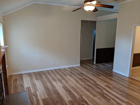 Maln living area with wood burning fireplace and high ceilings