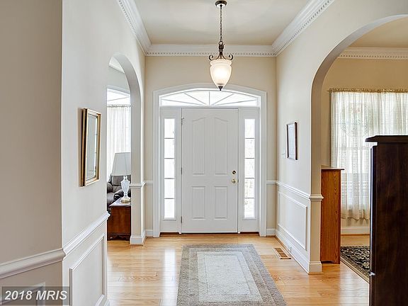 Entry w/glowing hardwoods and Gracious moldings
