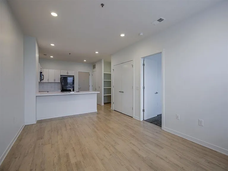 Living room and bedroom entrance in a unit at The Rise.
