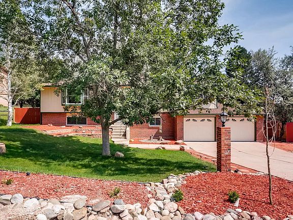 Beautifully groomed and well-shaded front yard for this 5BD 3 BA 2,828 sq ft home with lots of trees and sitting on .23 acre lot