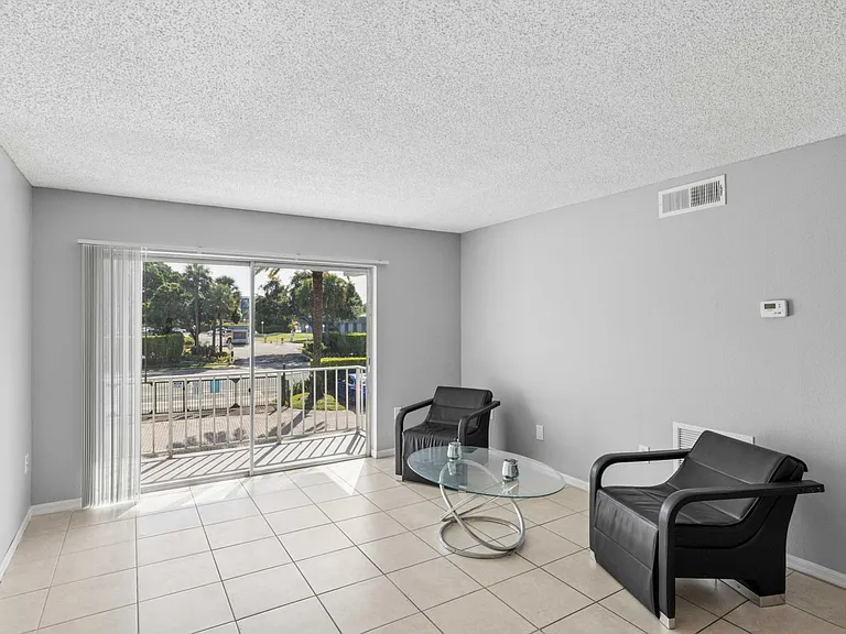 Step into the inviting living space at Clear Lake Palms Apartments, showcasing open layouts and modern finishes. Enjoy natural light flooding through wide windows and stylish design. Schedule a tour today to see your future home!