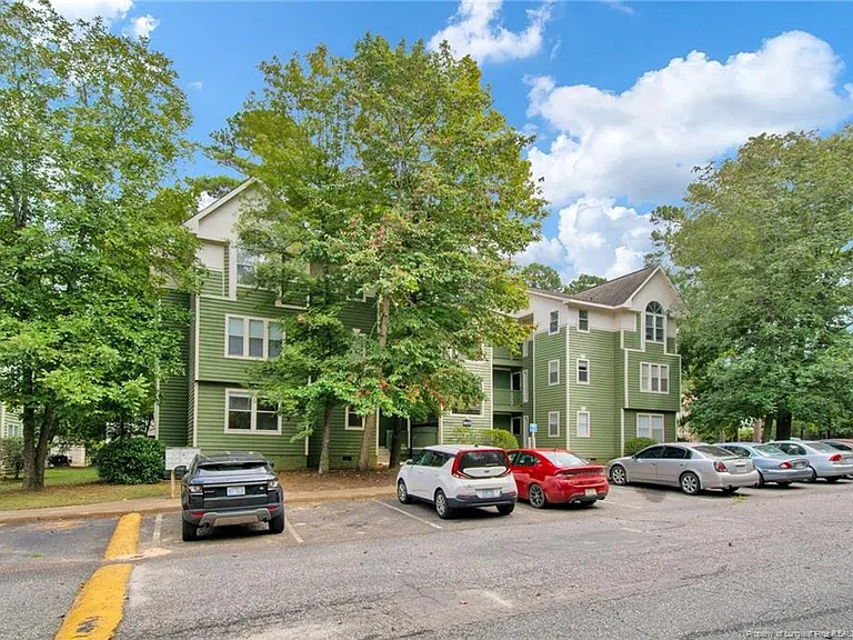 Front of building with parking spaces
