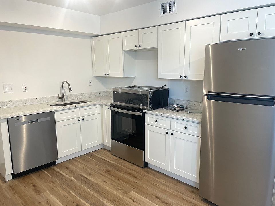 New kitchen featuring stainless appliances, dishwasher, and microwave