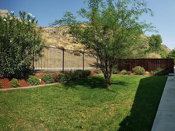Entrance from the street. Front door is 1/3 of the way down the house