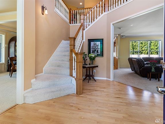 Grand foyer with open concept entry. Refinished hardwood floors throughout. 
