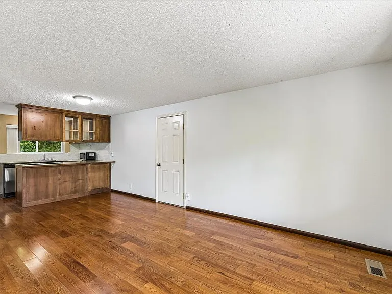 Light-filled living room w/ entry to garage