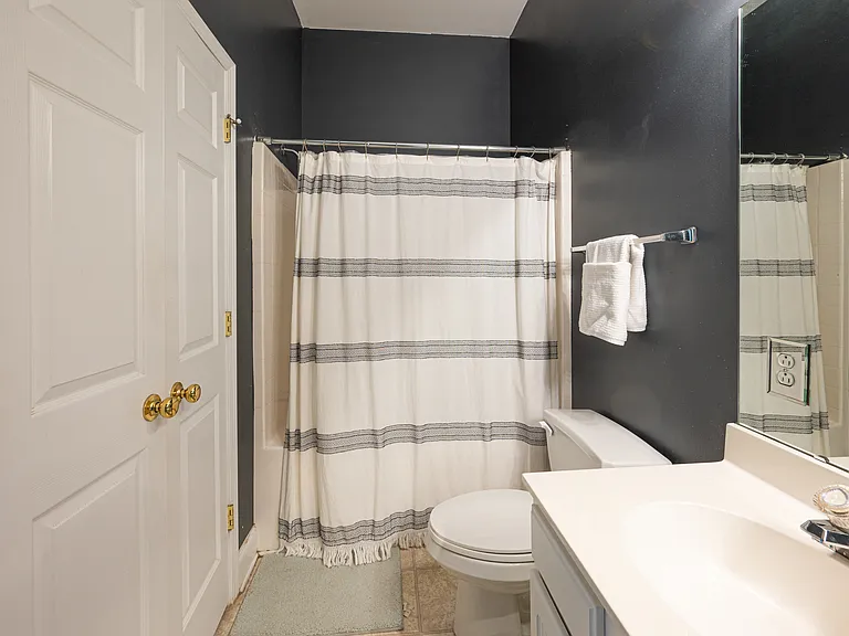 Full shower with tub and storage closet