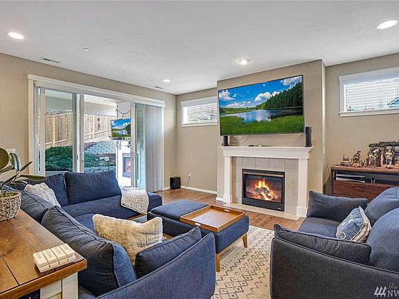 Living room with cozy gas fireplace and sliders to the covered deck.