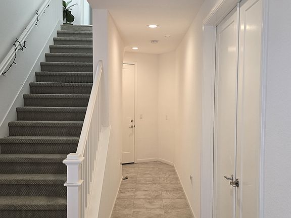 Downstairs room with an adjacent bathroom and walk-in closet, offering a quiet and private space ideal for use as a guest room or home office.