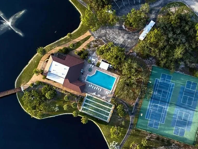 Walking path around large pond. Tennis and pickleball courts.