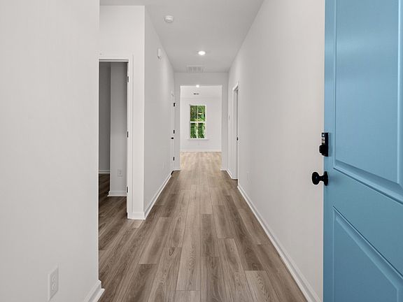 A welcoming entryway sets the tone with durable LVP floors and a light-filled path