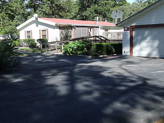 Side/Back View of home with screened in porch and garage