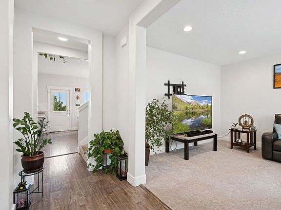Entrance to the home with the living room on the right and formal dining/den on the left.