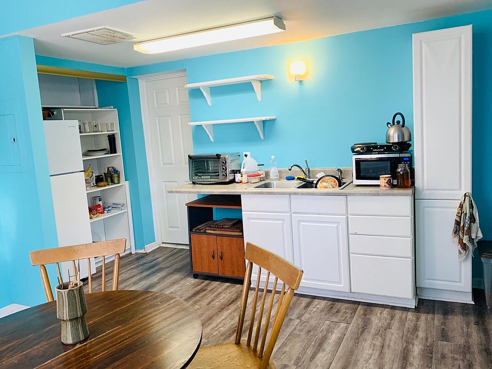 Kitchen Dining combo which features lots of cabinet and shelving storage, full size refrigerator and Luxury Vinyl Plank flooring.