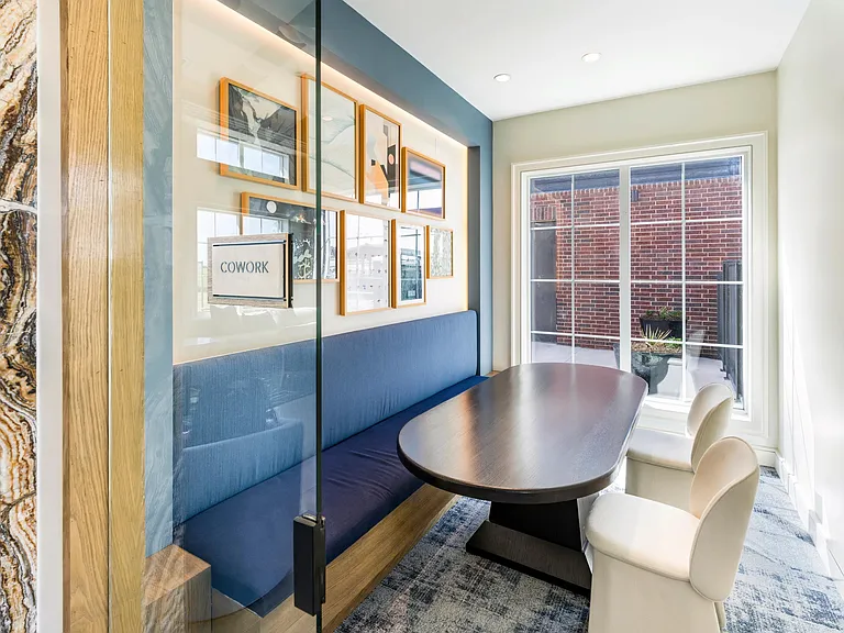 Stand-alone coworking offices with comfortable seating areas and private workstations.