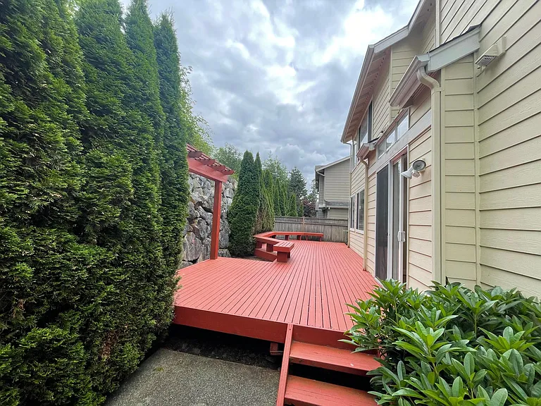 Backyard with Stone Rockery and Large Deck with seating area optimal for entertaining.