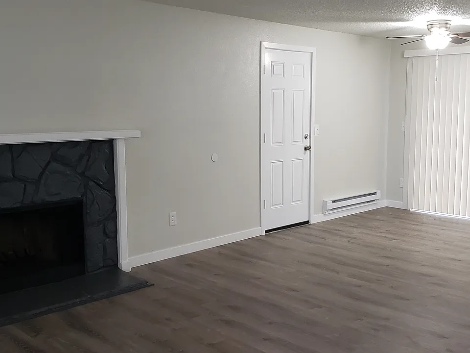 Another Picture of the Living Room, Dining Room and the Fireplace as you walk in the Front Door.