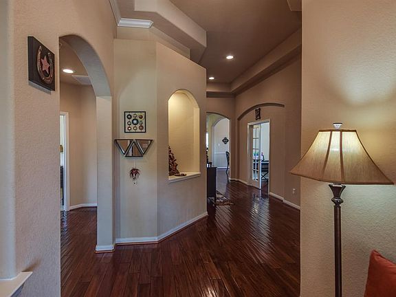 Gleaming warm hardwood floors. French doors lead into the study. Beautiful art niches and arched doorways elevate this home.