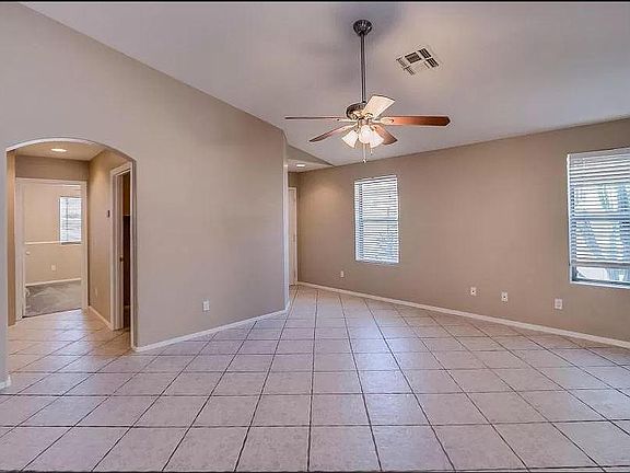 Large family room with tile floor, towards front door, front bedroom, and laundry.