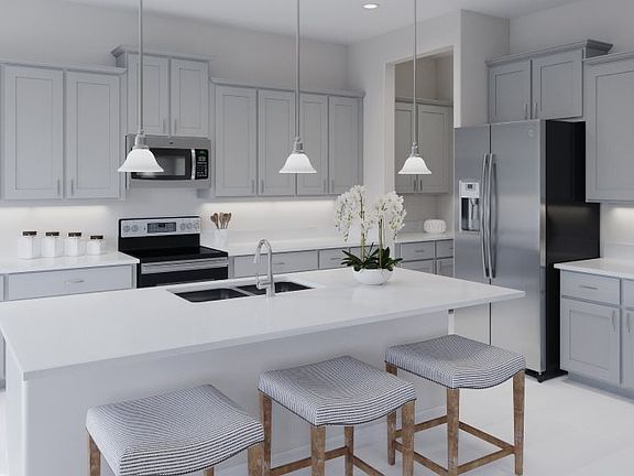 The kitchen offers a modern open design, complete with stylish cabinetry and a spacious center islan