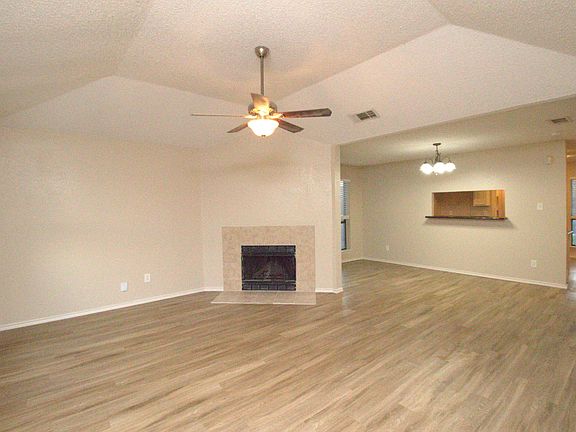 Family Room with woodburning fireplace and ceiling fan.