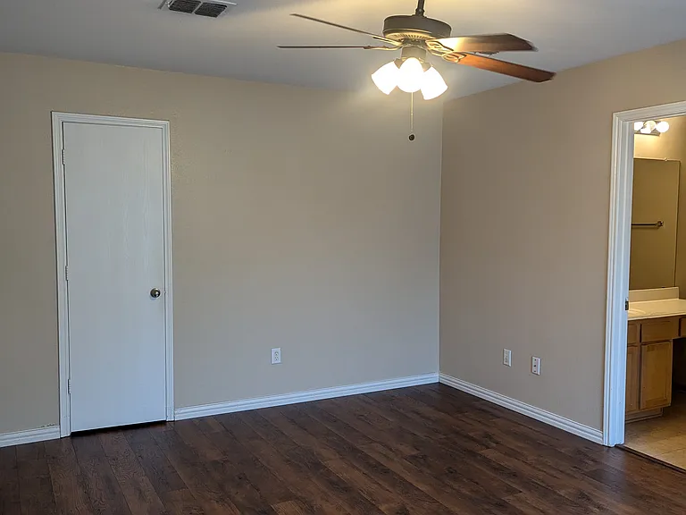 Primary bedroom looking into bathroom and closet door