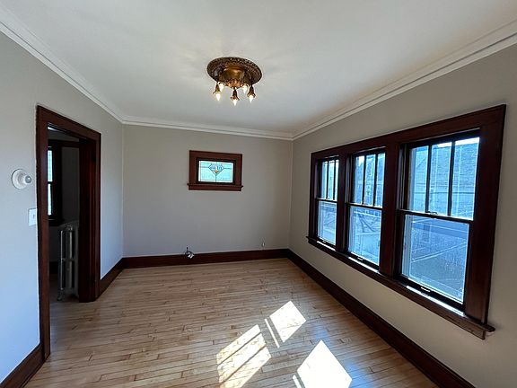 Original custom built-in stain-glass window and expresso trim woodwork