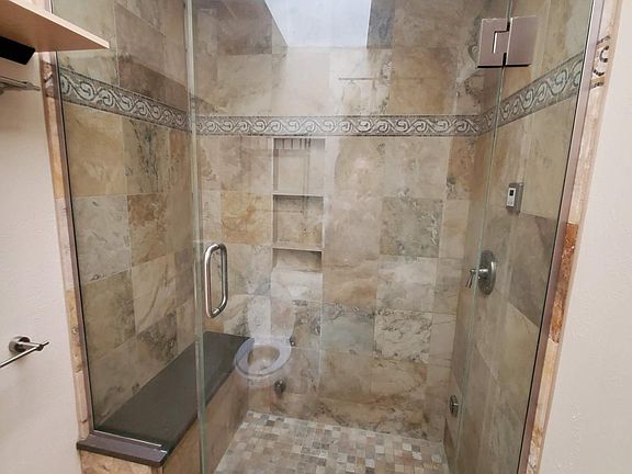 Upstairs bathroom. Has steam shower and skylight.