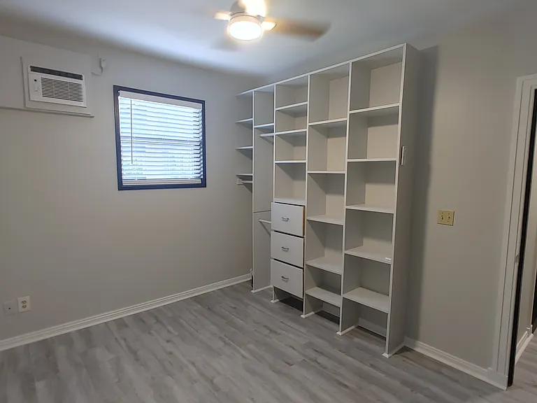 Bedroom with built-in cabinets/shelving