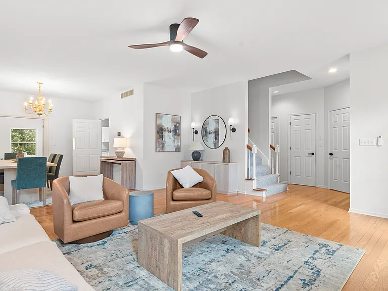Inviting main living room with a cozy fireplace, comfortable furnishings, and large windows.