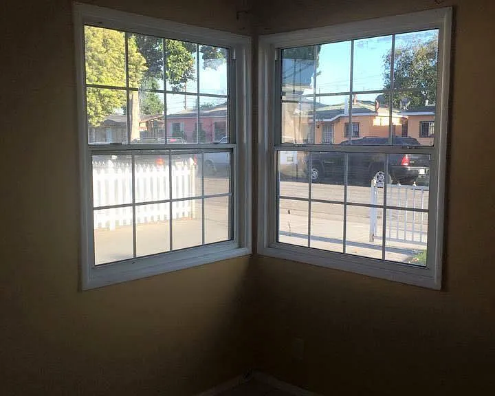 Living room looks out into street. Walls are now white.