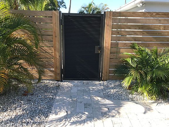 Front Entrance to the Property with Locked Gate and 6 Foot High Modern Fence around Perimeter of Property!