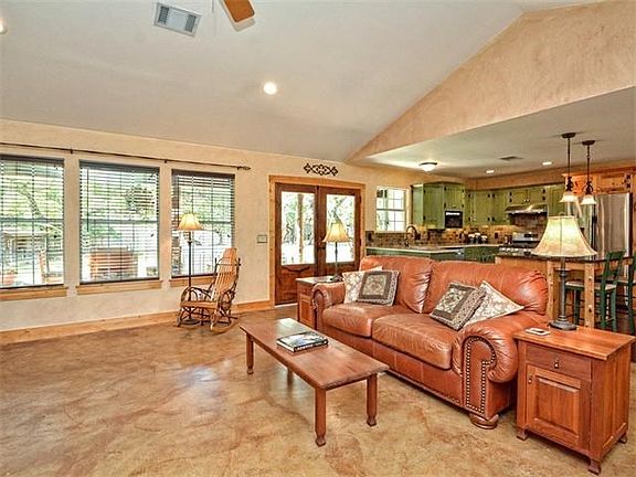 Built by hand, double mesquite doors lead to back yard.