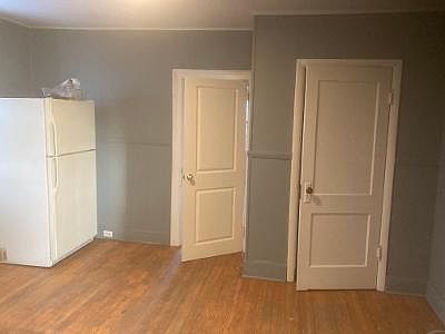 Kitchen with adjoining bedroom and closet.