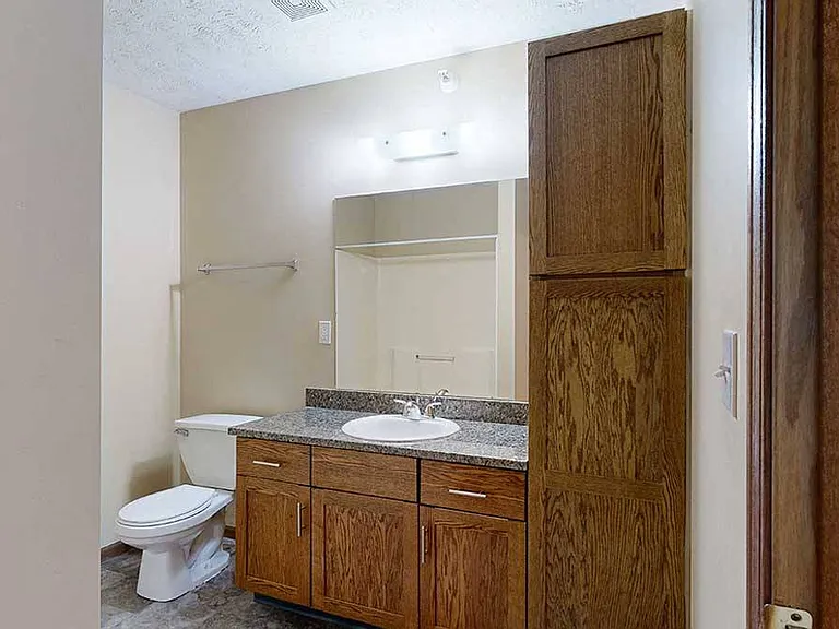 This renovated apartment features an updated bathroom with a granite vanity sink and extra storage for all your essentials.