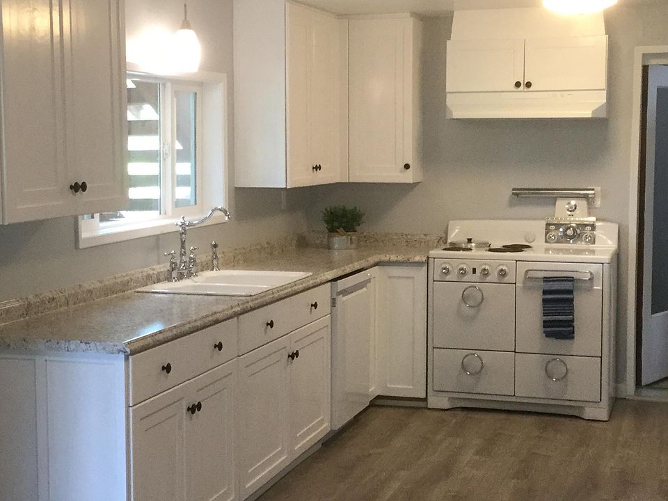 Kitchen light and bright with lots of cabinets. Lazy Susan in corner maximizes storage.