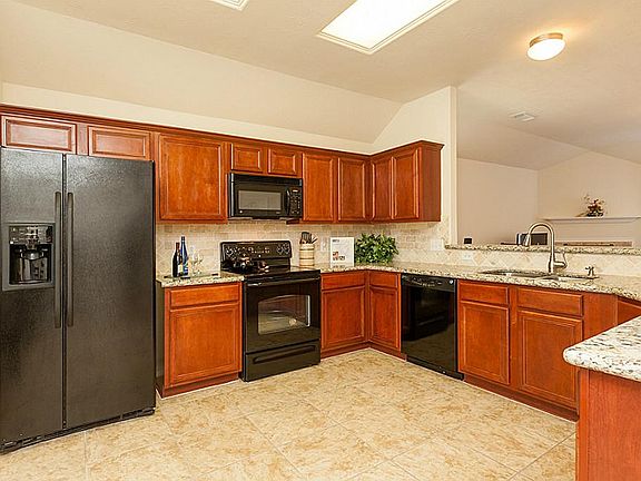 SPACIOUS KITCHEN WITH GRANITE COUNTERS, TILED BACKSPLASH AND FLOORING ~