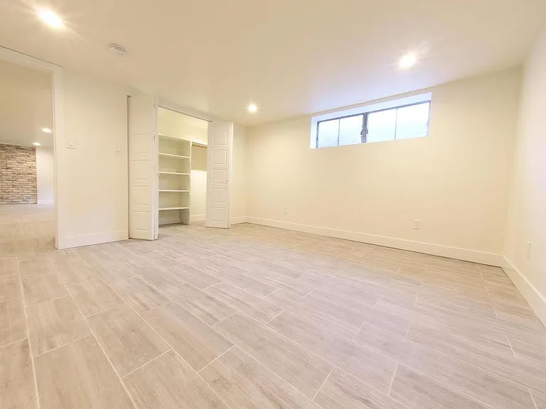 Basement Master Bedroom with Custom Closet and recessed lighting.