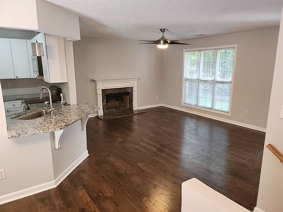 Family room with fireplace. Breakfast bar area view to kitchen.