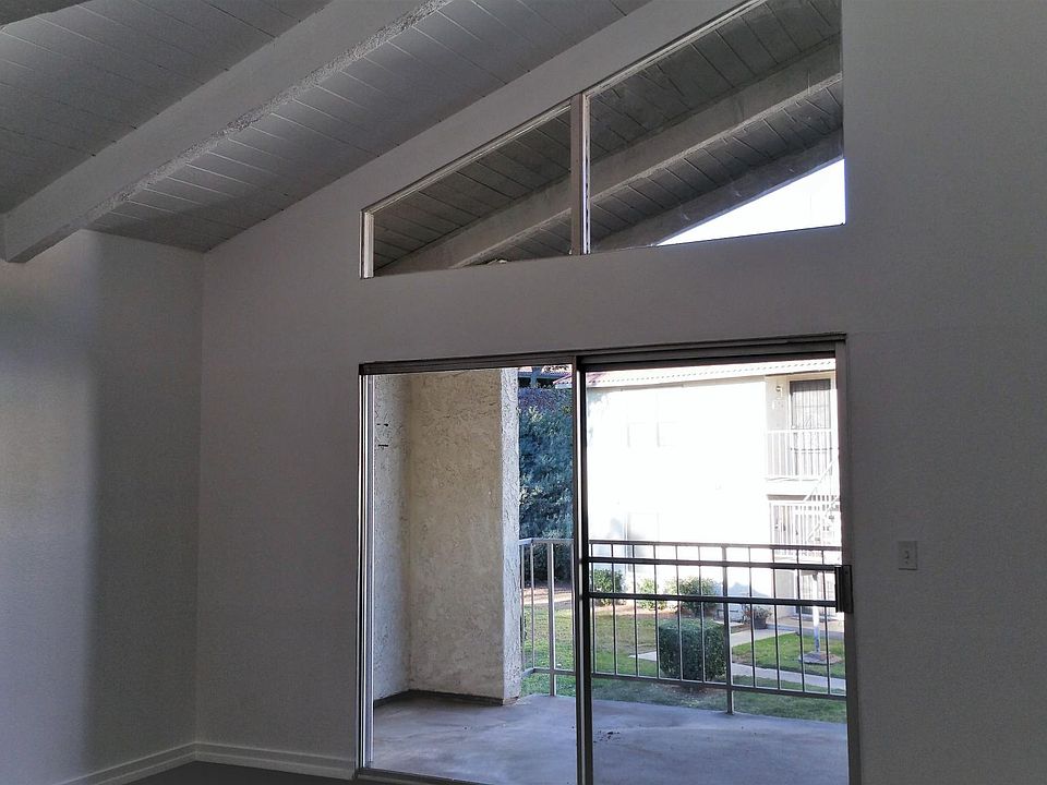 Living Room with vaulted ceiling, sliding patio door and extra-large balcony (with exterior storage closet).