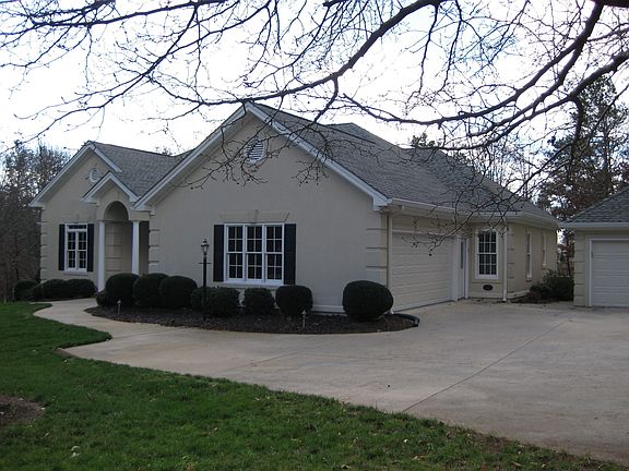 Nearly an acre of wooded privacy overlooking the 17th fairway, level driveway.
