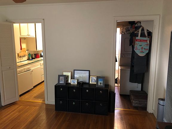 View from Front door towards kitchen and closet with washer and dryer