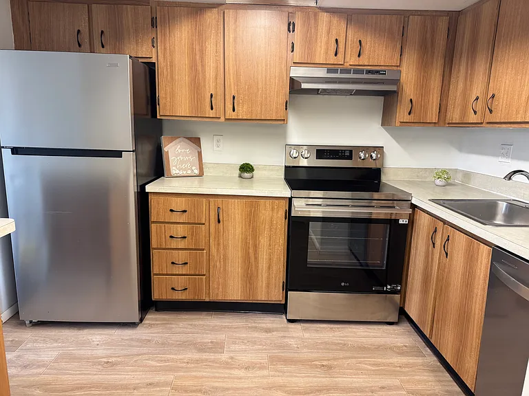 Kitchen with new stainless steel appliances.