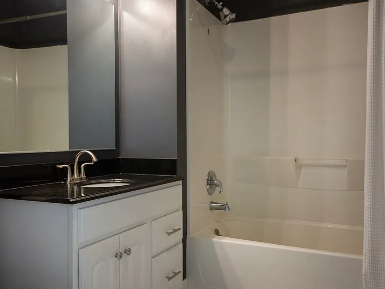 Stylishly updated bathroom with modern fixtures, contemporary lighting, and timeless tile flooring.
