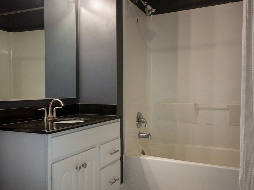 Stylishly updated bathroom with modern fixtures, contemporary lighting, and timeless tile flooring.