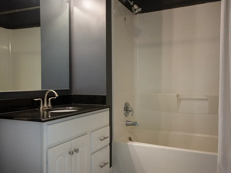 Stylishly updated bathroom with modern fixtures, contemporary lighting, and timeless tile flooring.