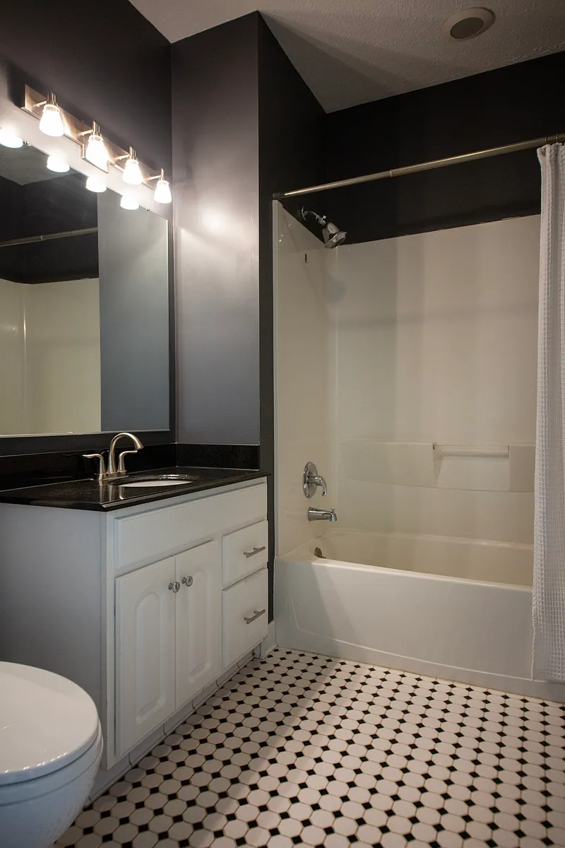 Stylishly updated bathroom with modern fixtures, contemporary lighting, and timeless tile flooring. - 3311 E Fairfax Rd #2