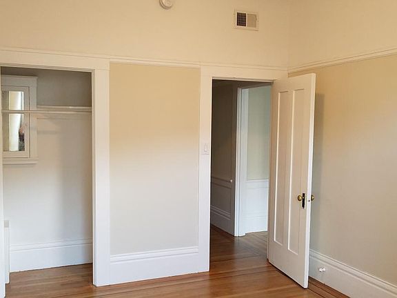 Other side of the bedroom, closet, and door leading to hallway